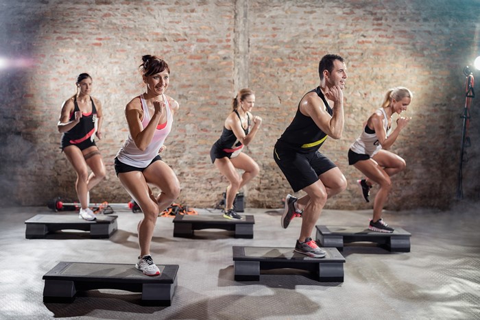 Group Fitness Class Performing Step Aerobics