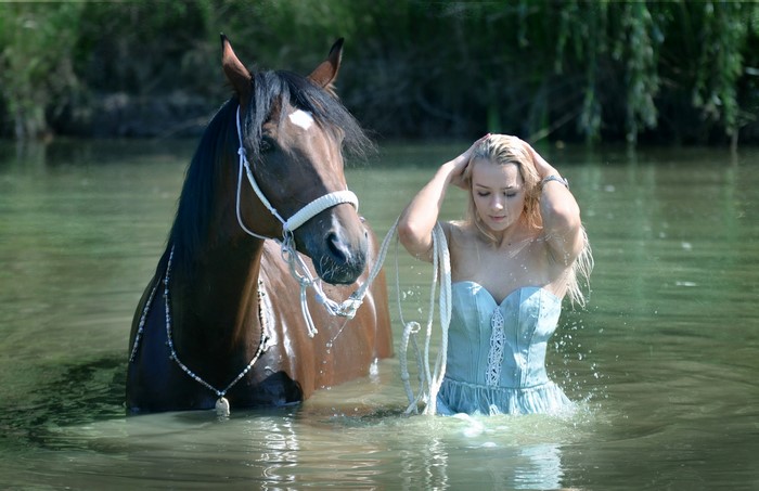 Woman and horse in water