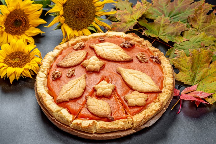 Autumn pie with sunflowers and maple leaves