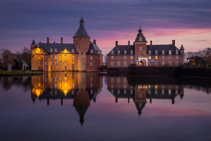 Castle reflection in pond at dusk in Germany