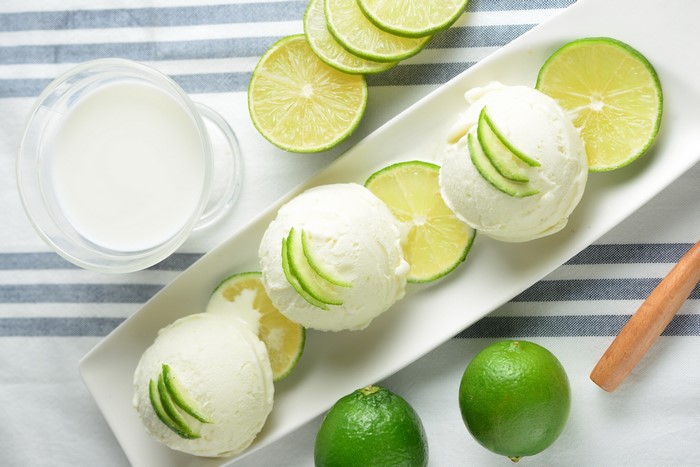 Lime ice cream scoops with lime slices and milk