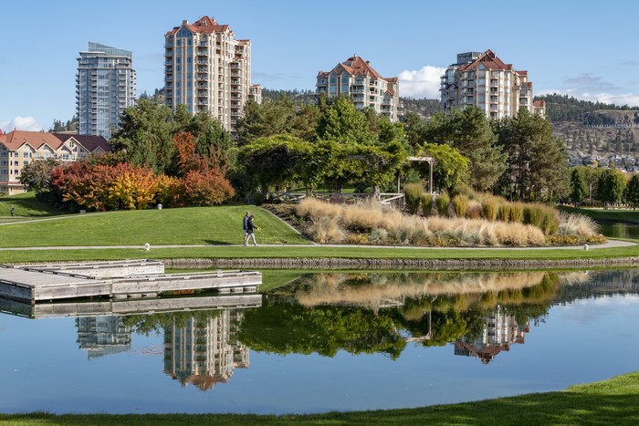 Park with buildings and lake in Kelowna, Canada