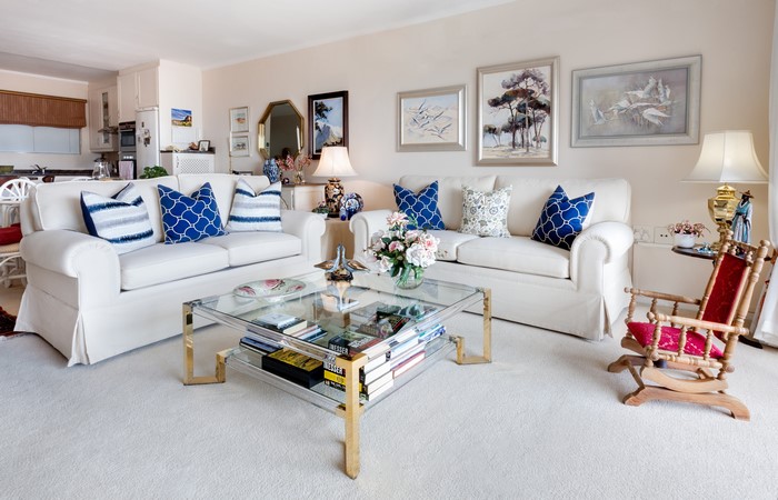 Living room with sofas, coffee table, and rocking chair