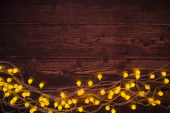 Christmas fairy lights on wood planks