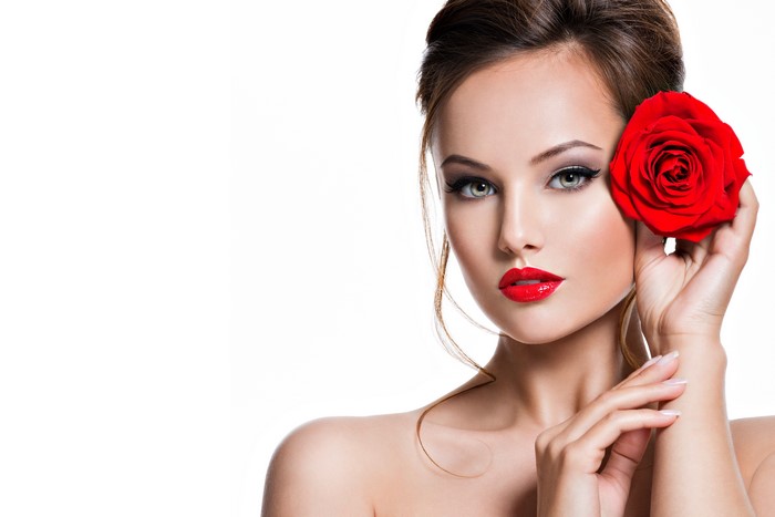 Woman with red rose and makeup