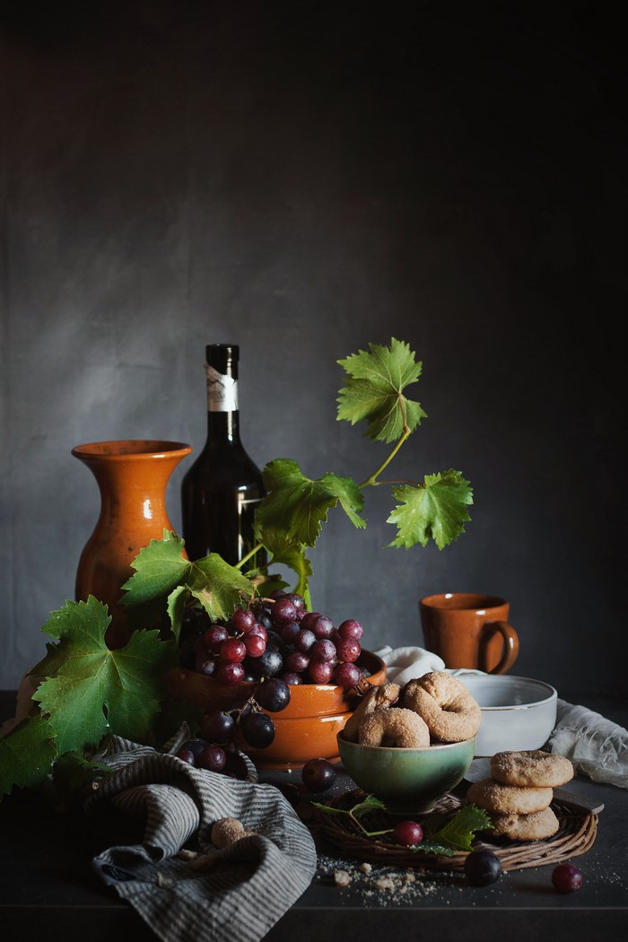 Still life with grapes, bottle, jug, and cookies