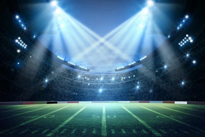 Football stadium with bright lights and field