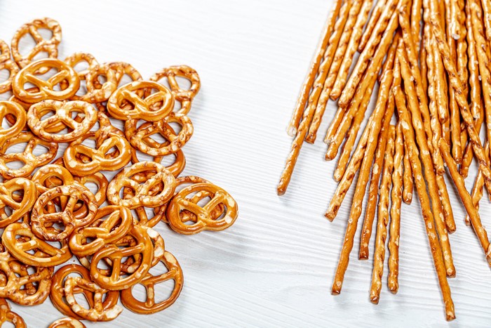 Pretzels and salty sticks on a white surface