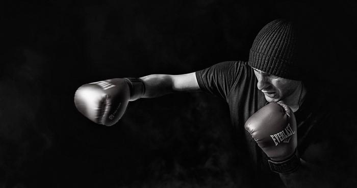 Man in Winter Hat Boxing with Everlast Gloves