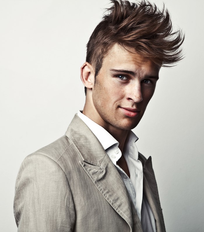 Man with spiky hair wearing a suit jacket