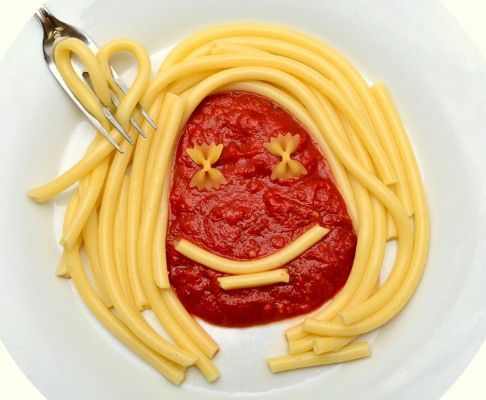 Pasta face with tomato sauce and fork