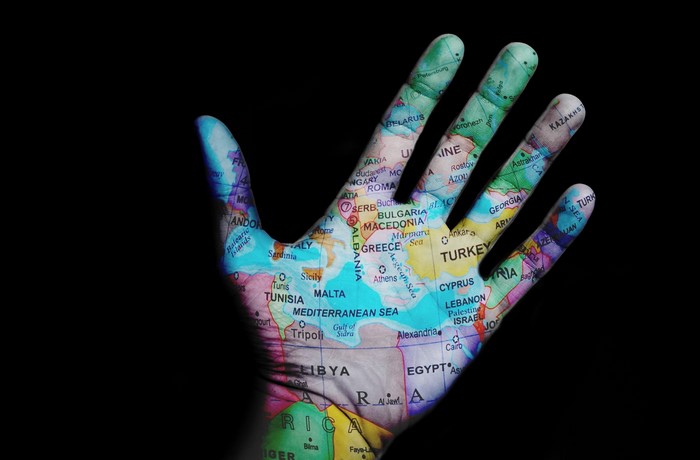 Hand with map of Europe and Africa