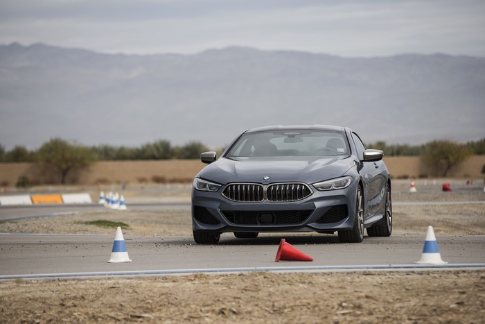 Grey BMW M850i xDrive on a track with cones