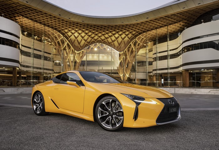 Yellow Lexus LC 500 in front of modern building