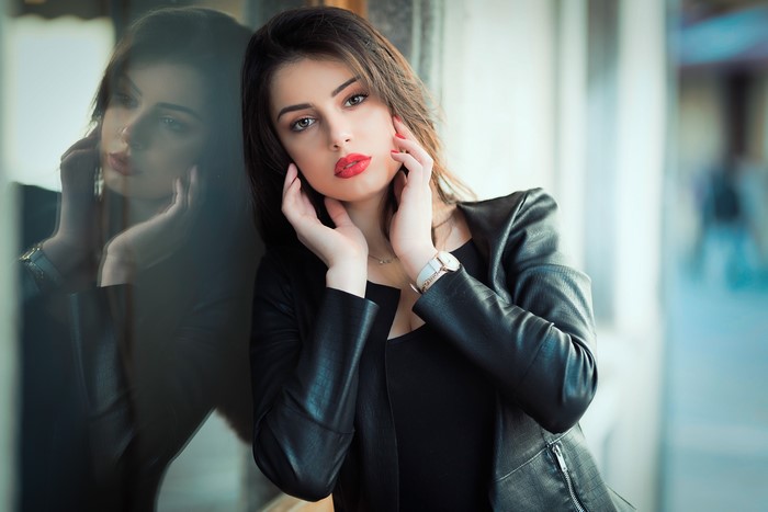 Woman in leather jacket with reflection