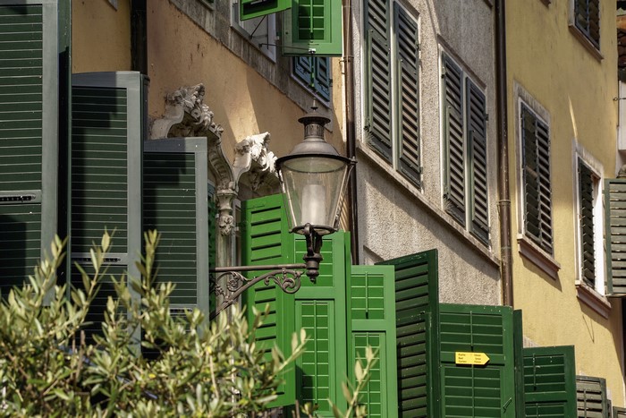 Building facade with green shutters and lantern in Solothurn, Switzerland