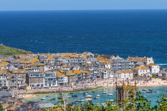 Coastal town with houses and boats in Cornwall, UK