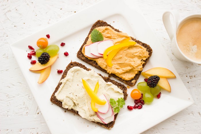 Breakfast with open-faced sandwiches and fruit