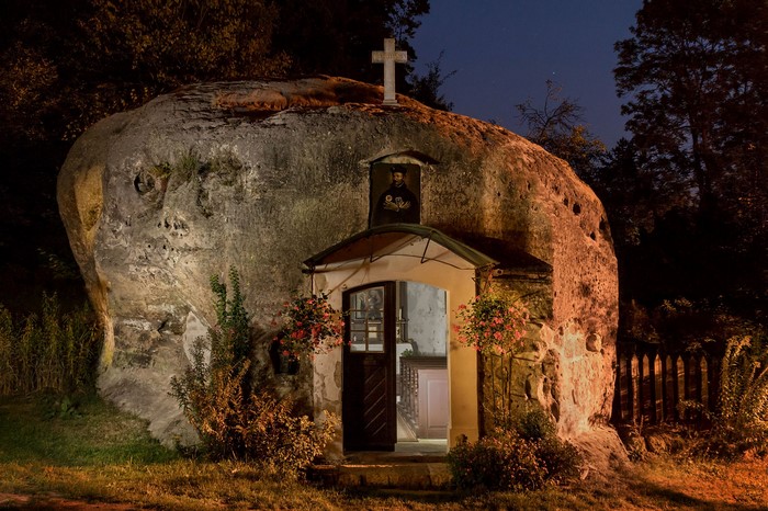 Chapel built into a rock formation at night