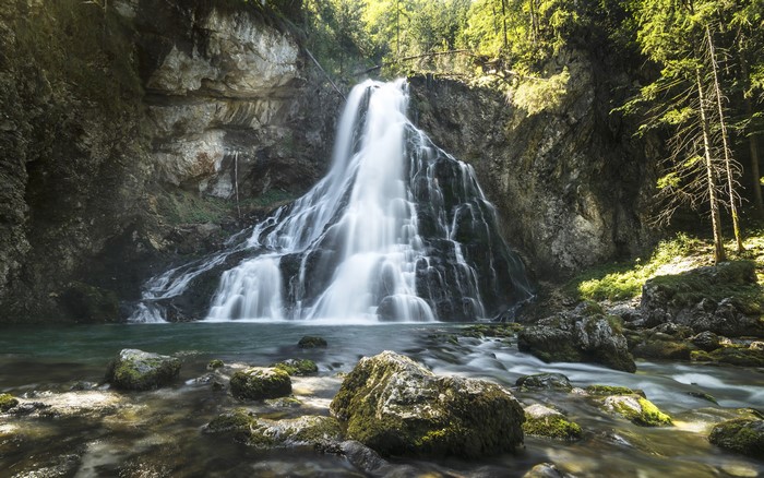 4K Waterfall over Mossy Rocks and Crag