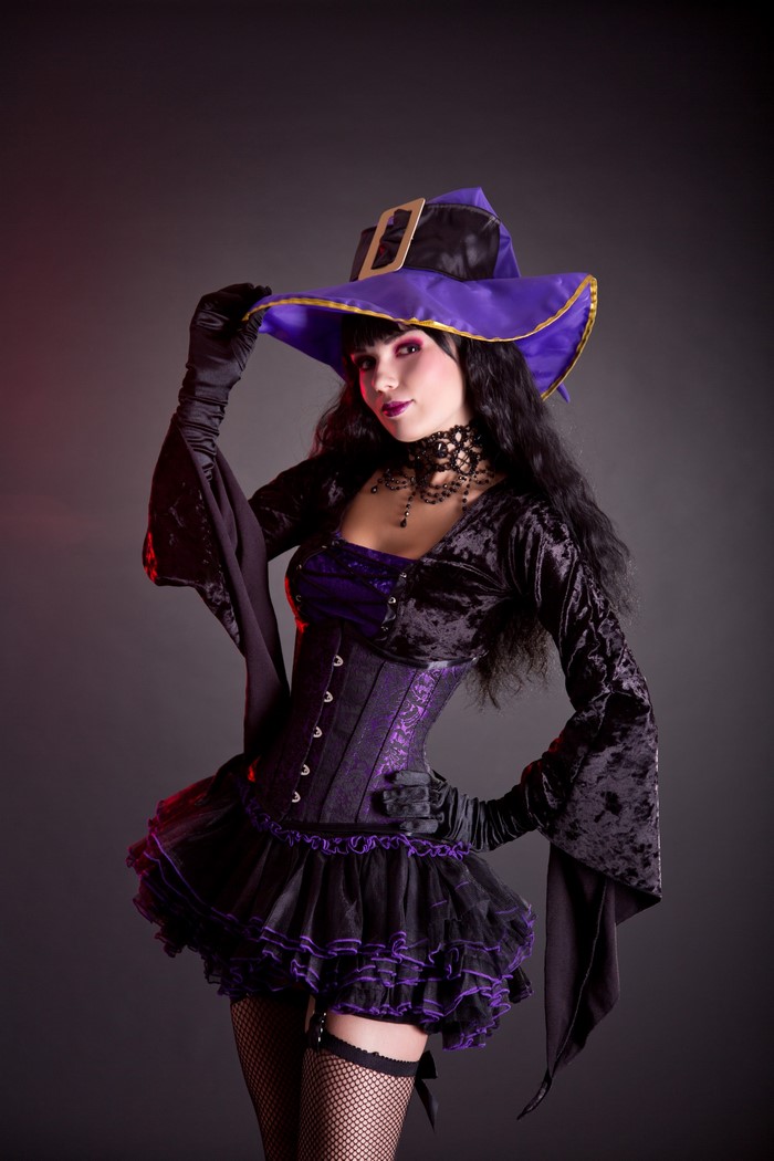 Woman in witch costume with purple hat and corset