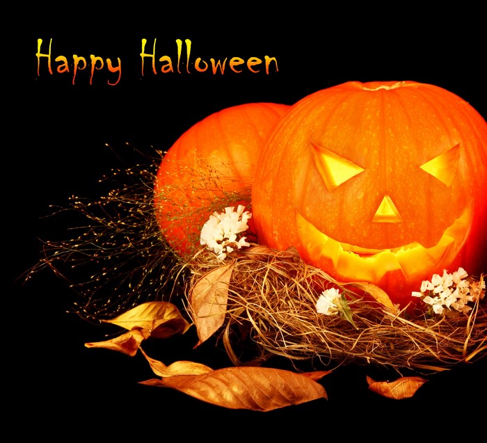 Happy Halloween carved pumpkins with foliage