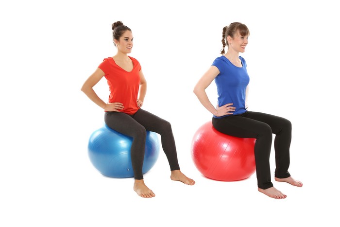Two women sitting on fitness balls