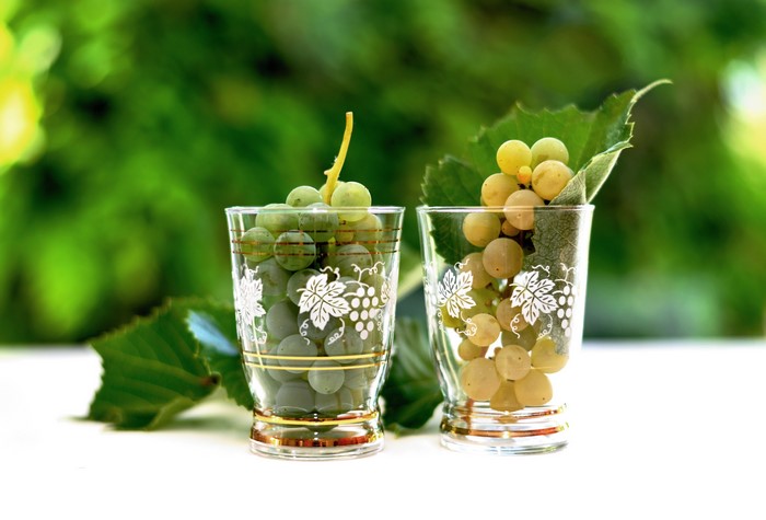Two glasses of grapes with bokeh background