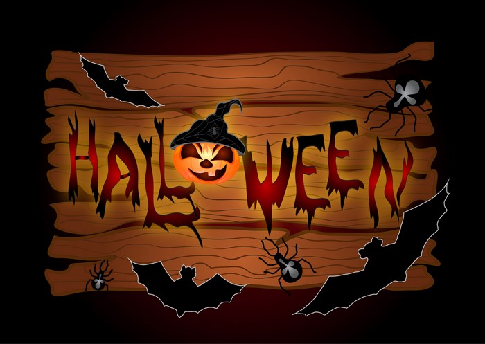 Halloween word art with pumpkin, bats, and spiders on wood