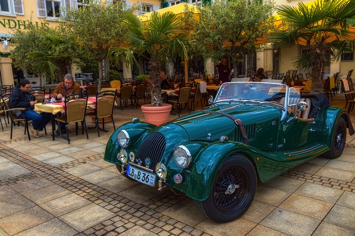 Green Morgan 4-4 Cabriolet parked outside a restaurant