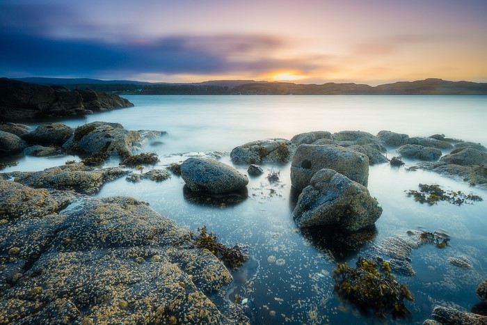 Rocky coast at sunrise in Kildonan, Scotland