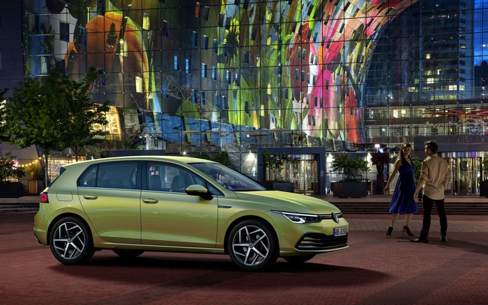 Volkswagen Golf R-Line hatchback parked in front of a modern building