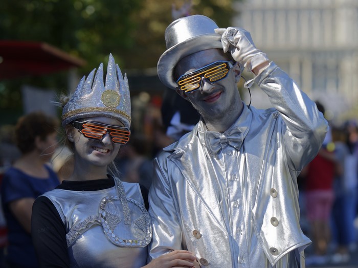Two people in silver cosplay with glasses