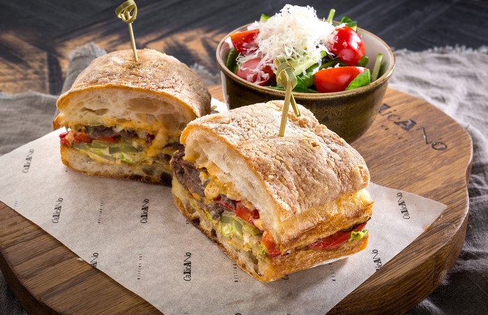 Sandwich with salad on a wooden board