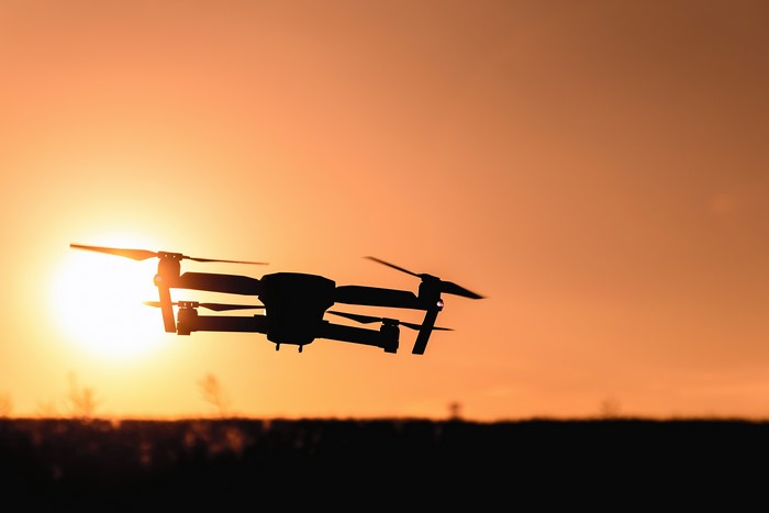 Drone flying at sunset