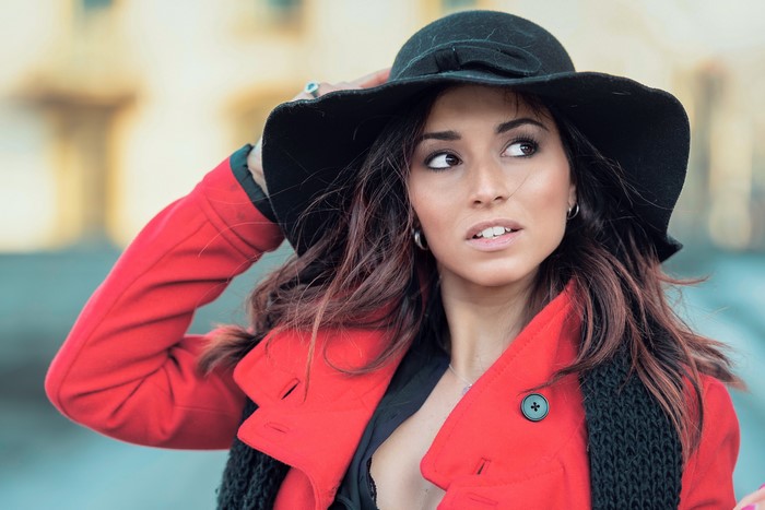 Woman in red coat and black hat