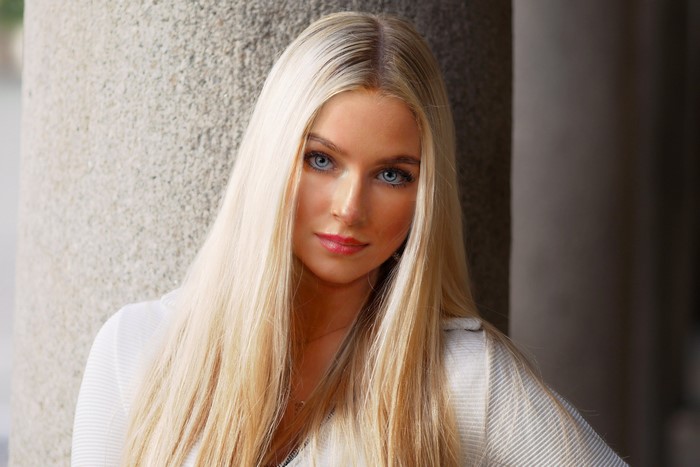Blonde woman with blue eyes looking at the camera