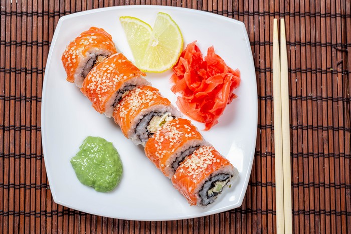 Sushi with Salmon, Wasabi, Ginger, and Lemon on a Plate