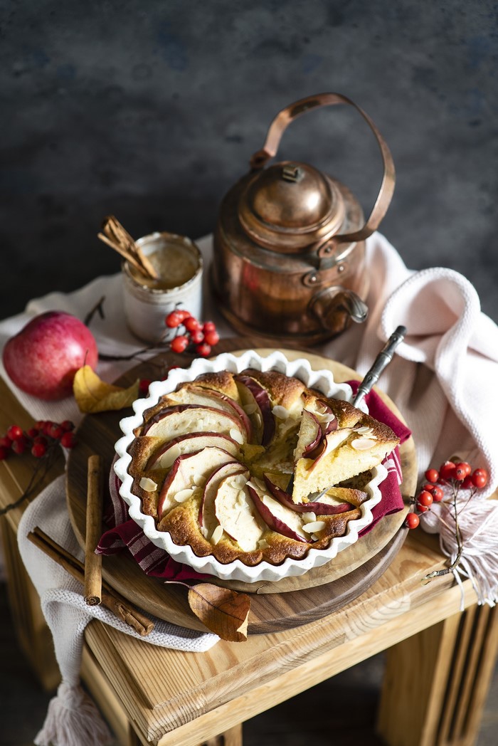 Apple pie with cinnamon and a copper kettle
