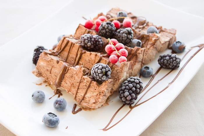 Chocolate ice cream loaf with berries and chocolate drizzle