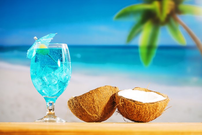 Blue Cocktail with Coconuts on a Beach