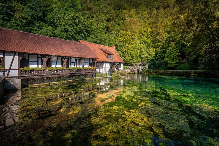 Watermill by a clear pond in Germany