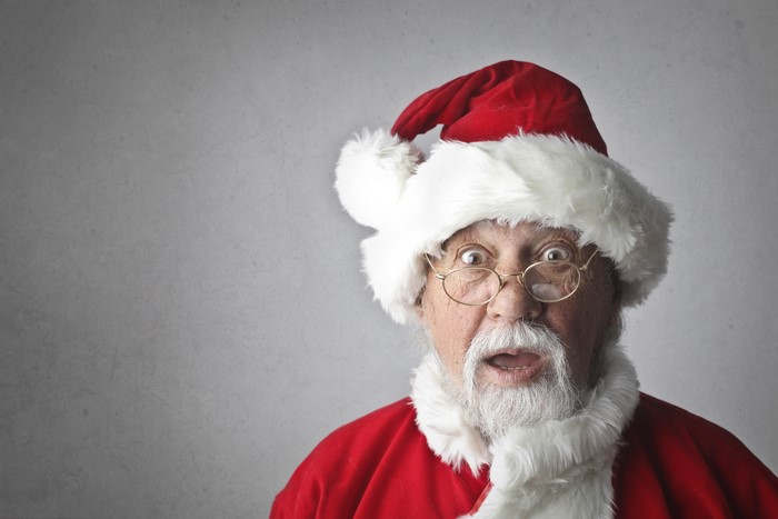 Santa Claus with surprised expression wearing glasses