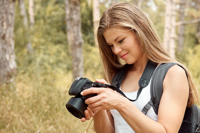 Woman with camera in forest