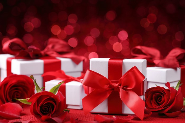 Gift boxes with red roses and bokeh