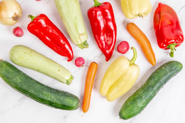 Assortment of fresh vegetables on a white marble background