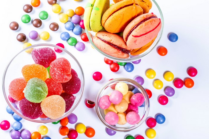 Sweets: Marmalade, Candy, Dragee, Macaron on White Background