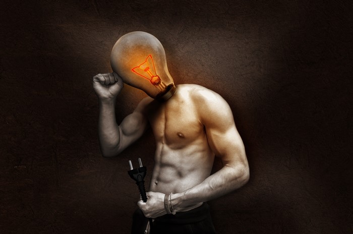 Man with light bulb head holding power plug