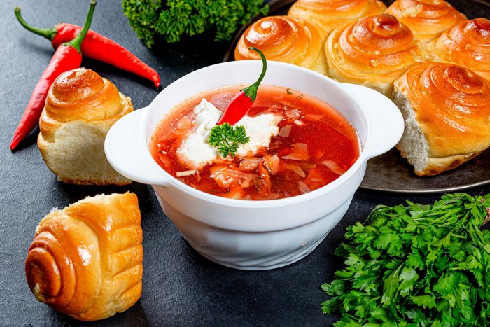 Borscht soup with buns and chili peppers