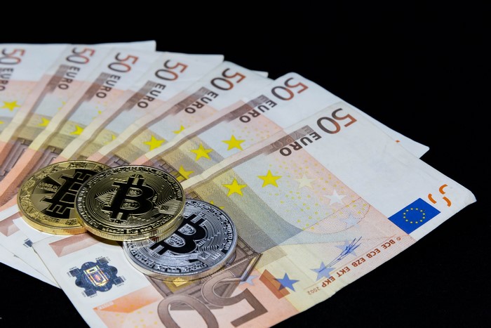 Euro banknotes with Bitcoin coins